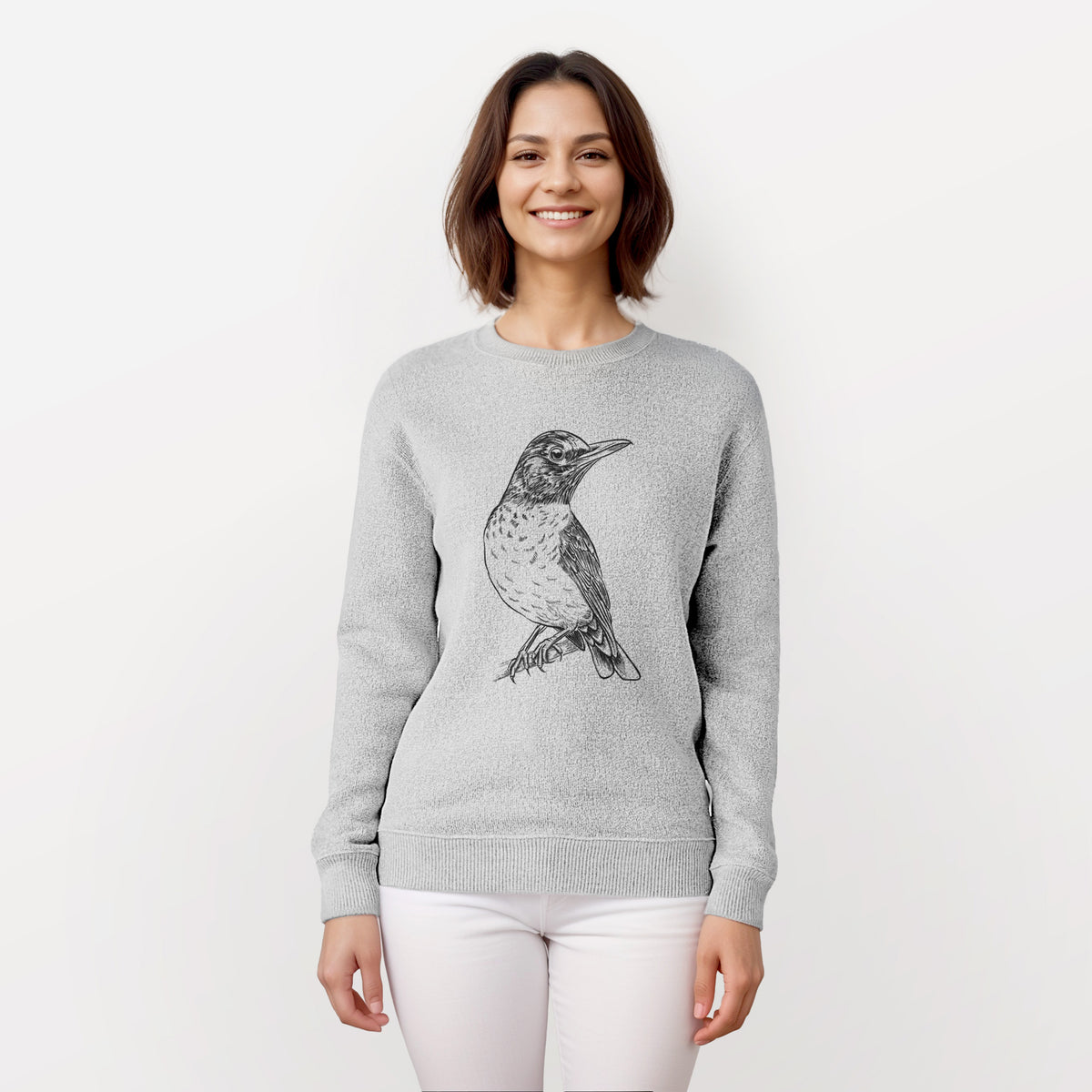 Woman wearing a knit sweatshirt printed with a detailed black ink sketch of an American robin perched on a branch.