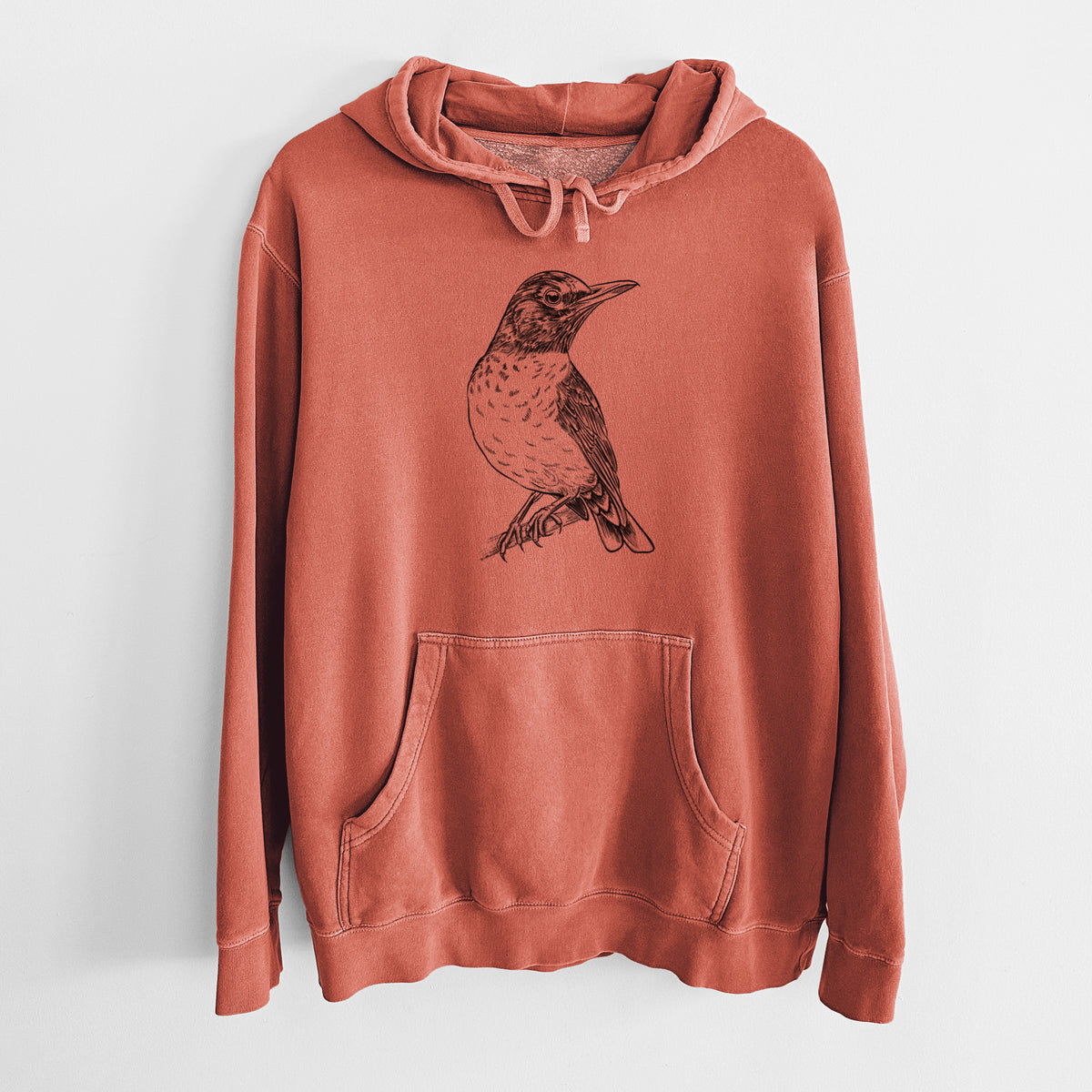 Amber orange pigment dyed hoodie laid flat, printed with a detailed black ink sketch of an American robin perched on a branch.