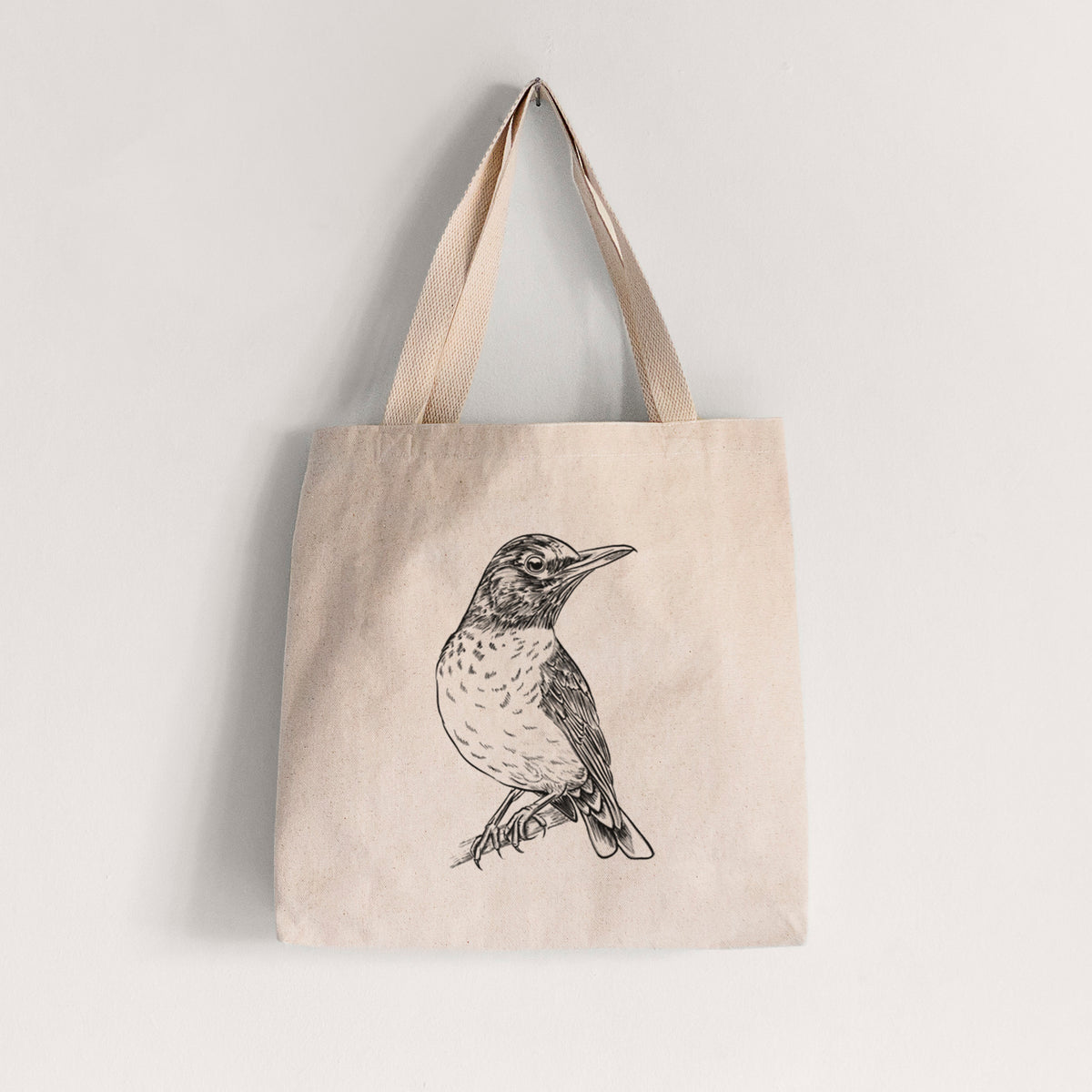 Natural canvas tote bag printed with a detailed black ink sketch of an American robin perched on a branch.