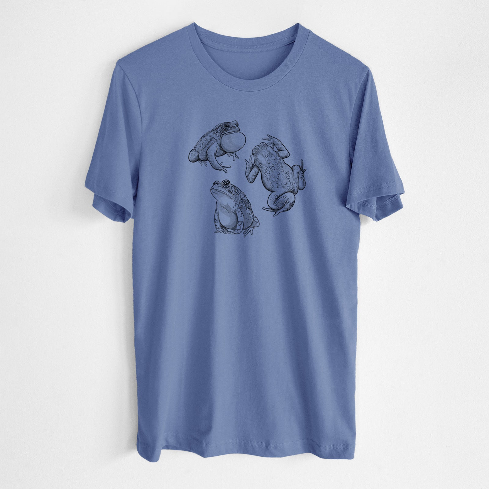 Blue bell lightweight cotton t-shirt laid flat, printed with a black ink illustration of three American toads.