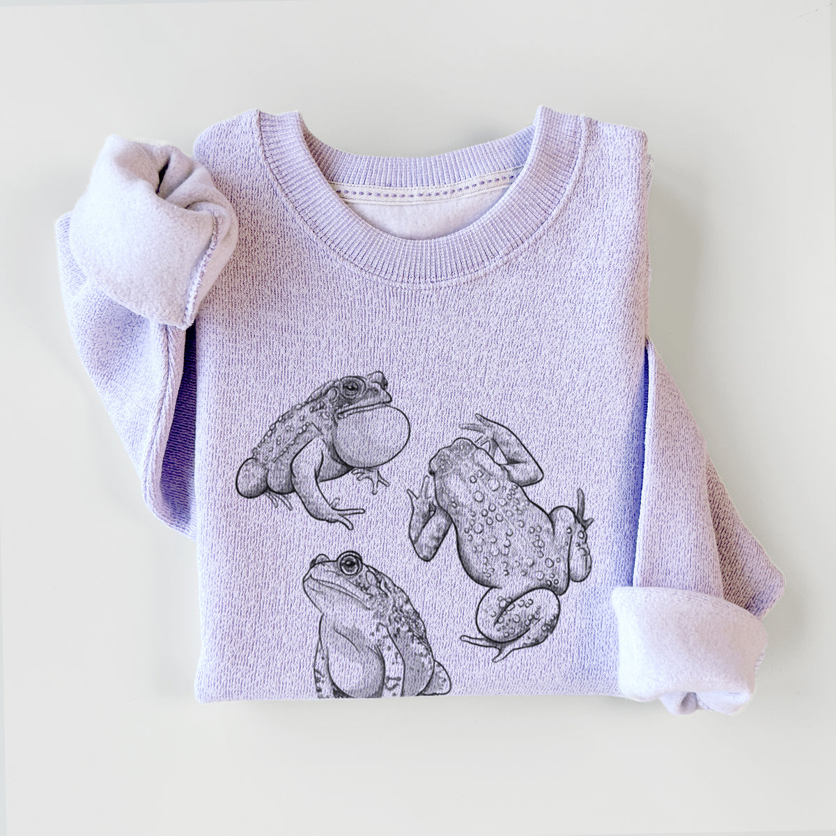 Ice purple knit sweatshirt printed with a black ink illustration of three American toads, styled flat.