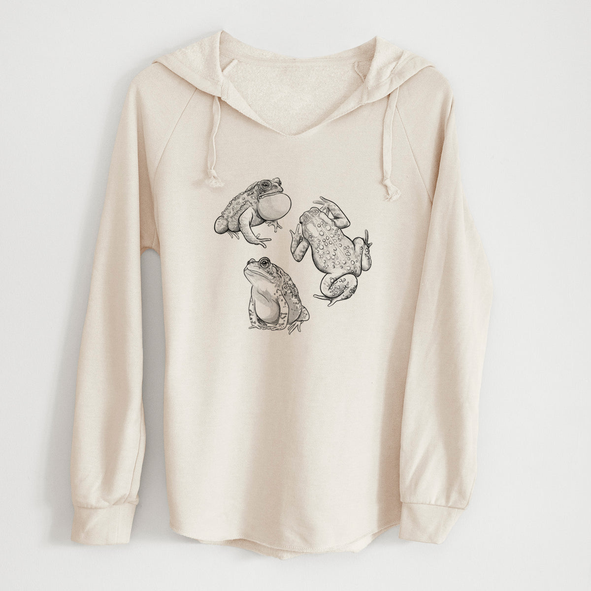 Bone cream women's Cali Wave hooded sweatshirt laid flat, printed with a black ink illustration of three American toads.