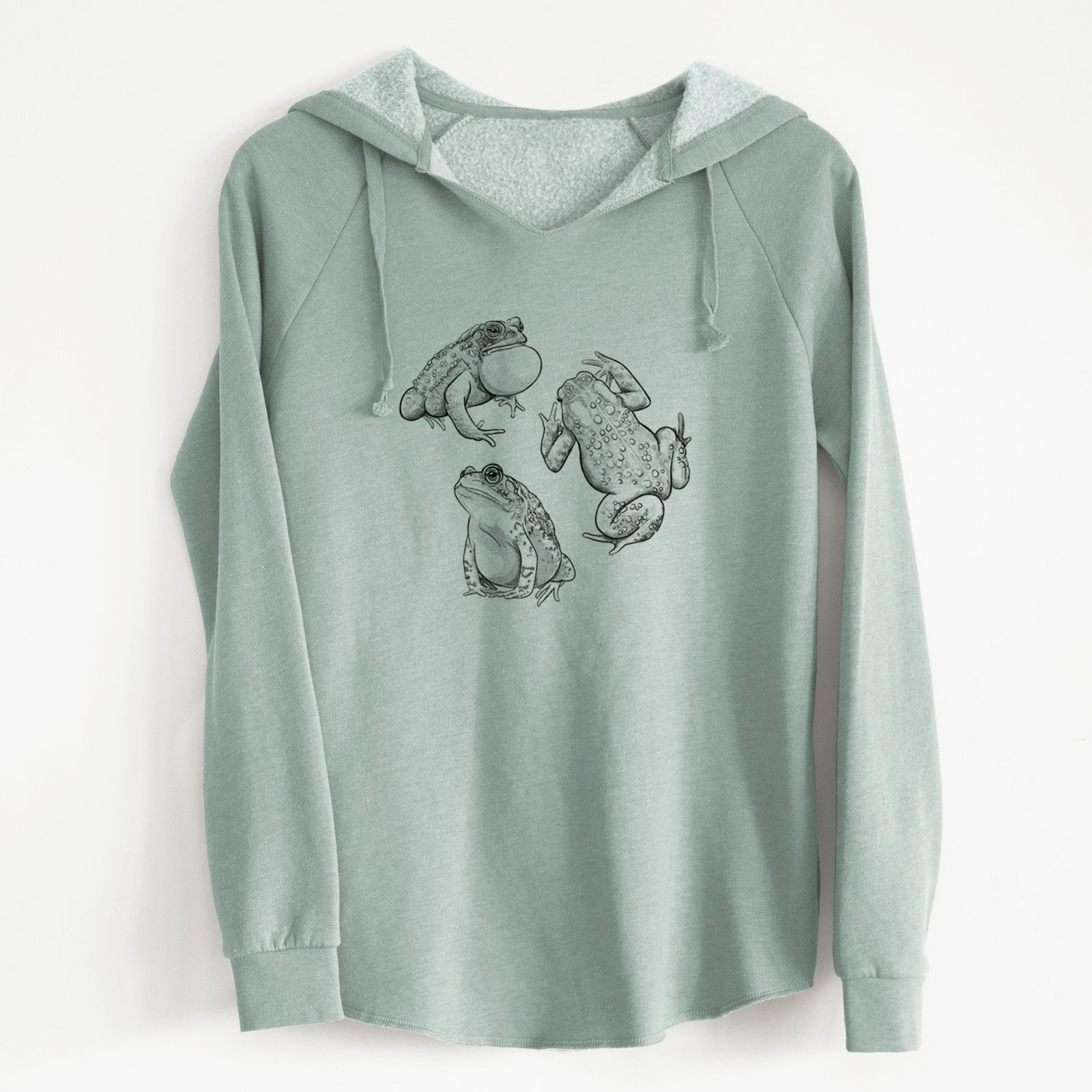 Sage green women's Cali Wave hooded sweatshirt laid flat, printed with a black ink illustration of three American toads.