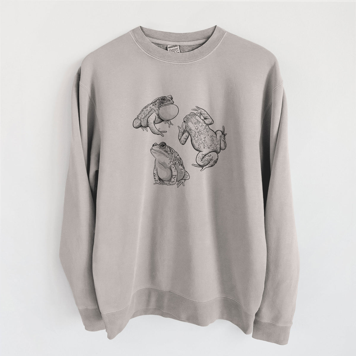 Cement grey pigment dyed crewneck sweatshirt laid flat, printed with a black ink illustration of three American toads.