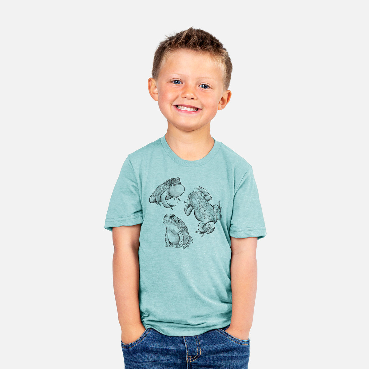 Smiling boy wearing a youth t-shirt printed with a black ink illustration of three American toads.
