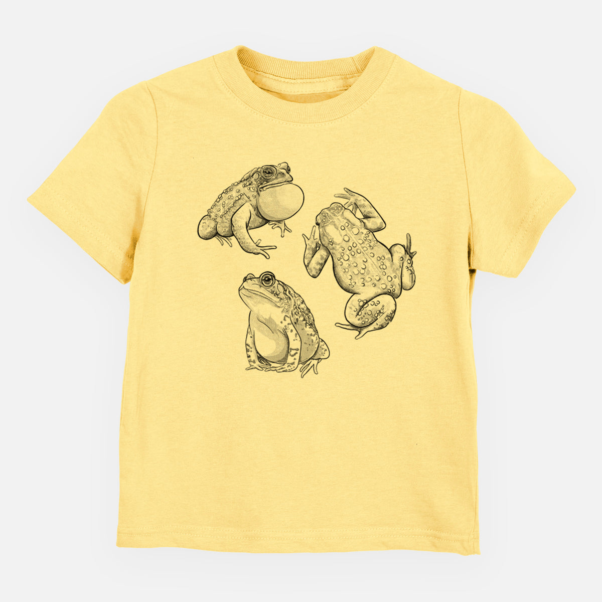 Butter yellow toddler t-shirt laid flat, printed with a black ink illustration of three American toads.