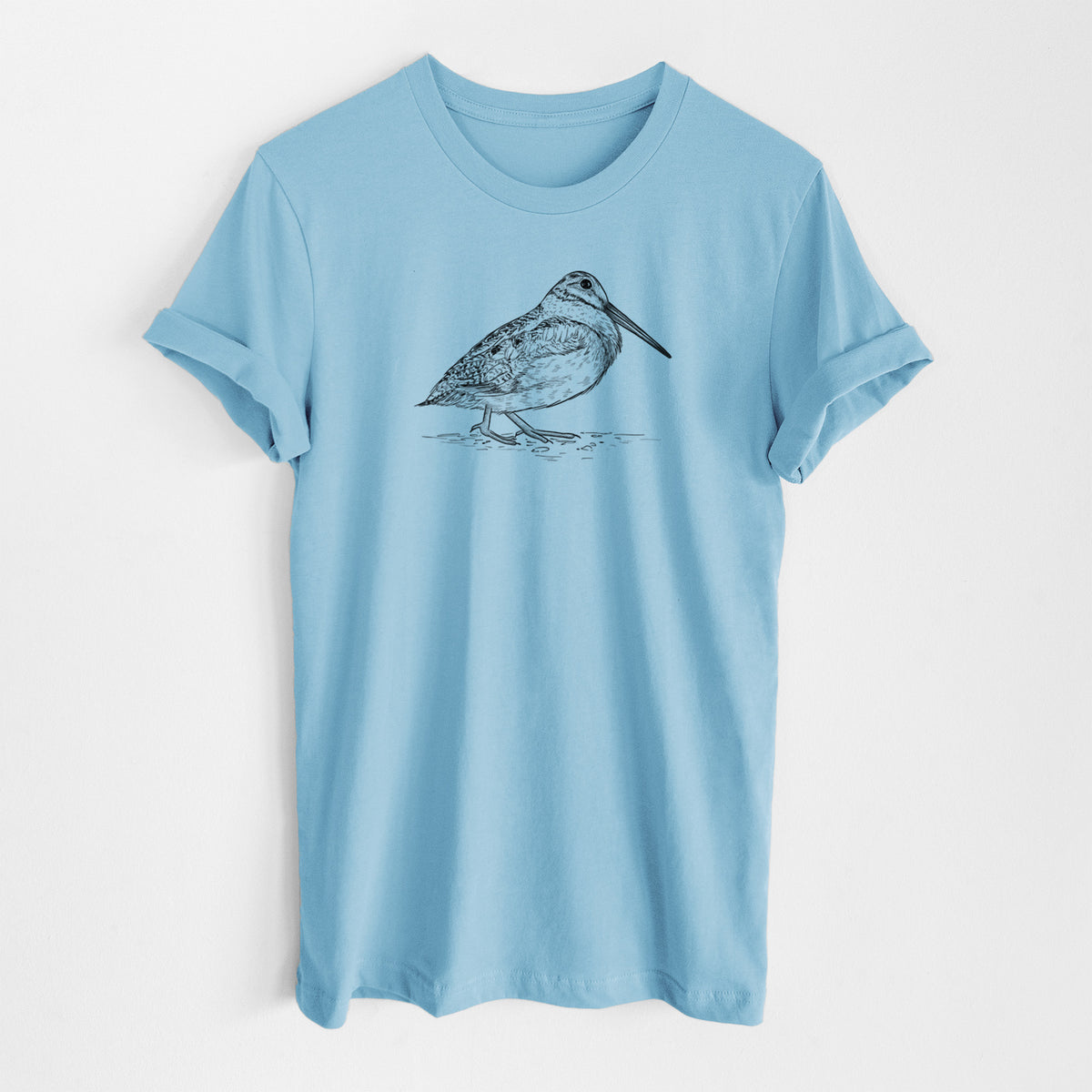 Ocean blue lightweight cotton t-shirt laid flat, printed with a detailed black ink sketch of an American woodcock standing on the ground.