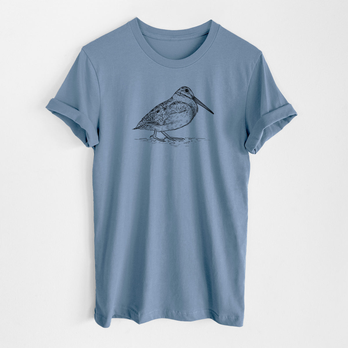 Steel blue lightweight cotton t-shirt laid flat, printed with a detailed black ink sketch of an American woodcock standing on the ground.