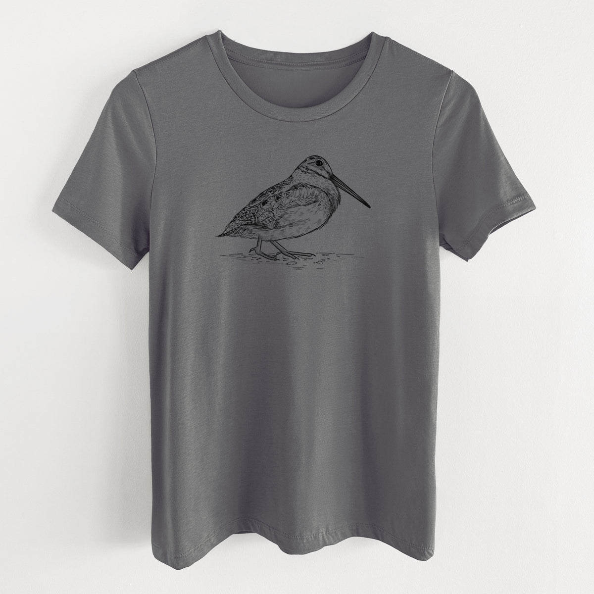 Asphalt women's relaxed fit cotton t-shirt laid flat, printed with a detailed black ink sketch of an American woodcock standing on the ground.