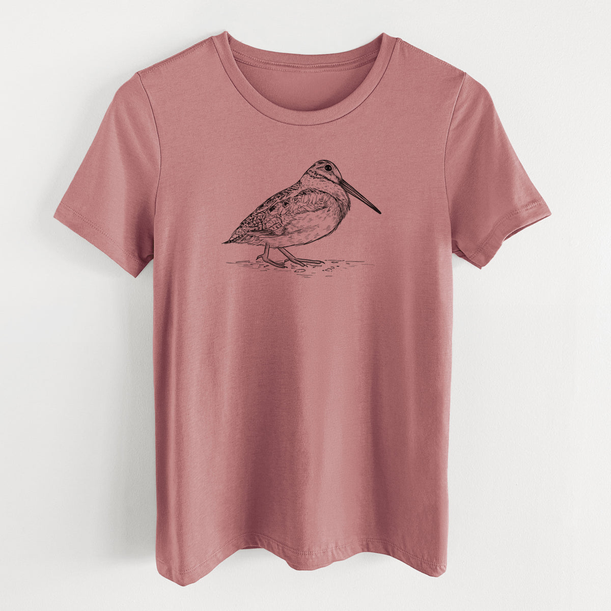 Mauve pink women's relaxed fit cotton t-shirt laid flat, printed with a detailed black ink sketch of an American woodcock standing on the ground.