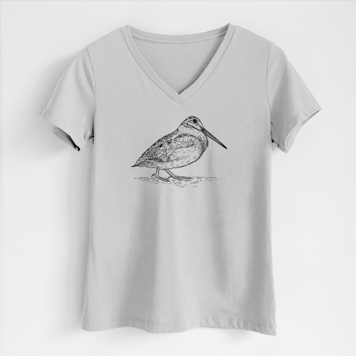 Lunar grey women's relaxed fit cotton V-neck t-shirt laid flat, printed with a detailed black ink sketch of an American woodcock standing on the ground.