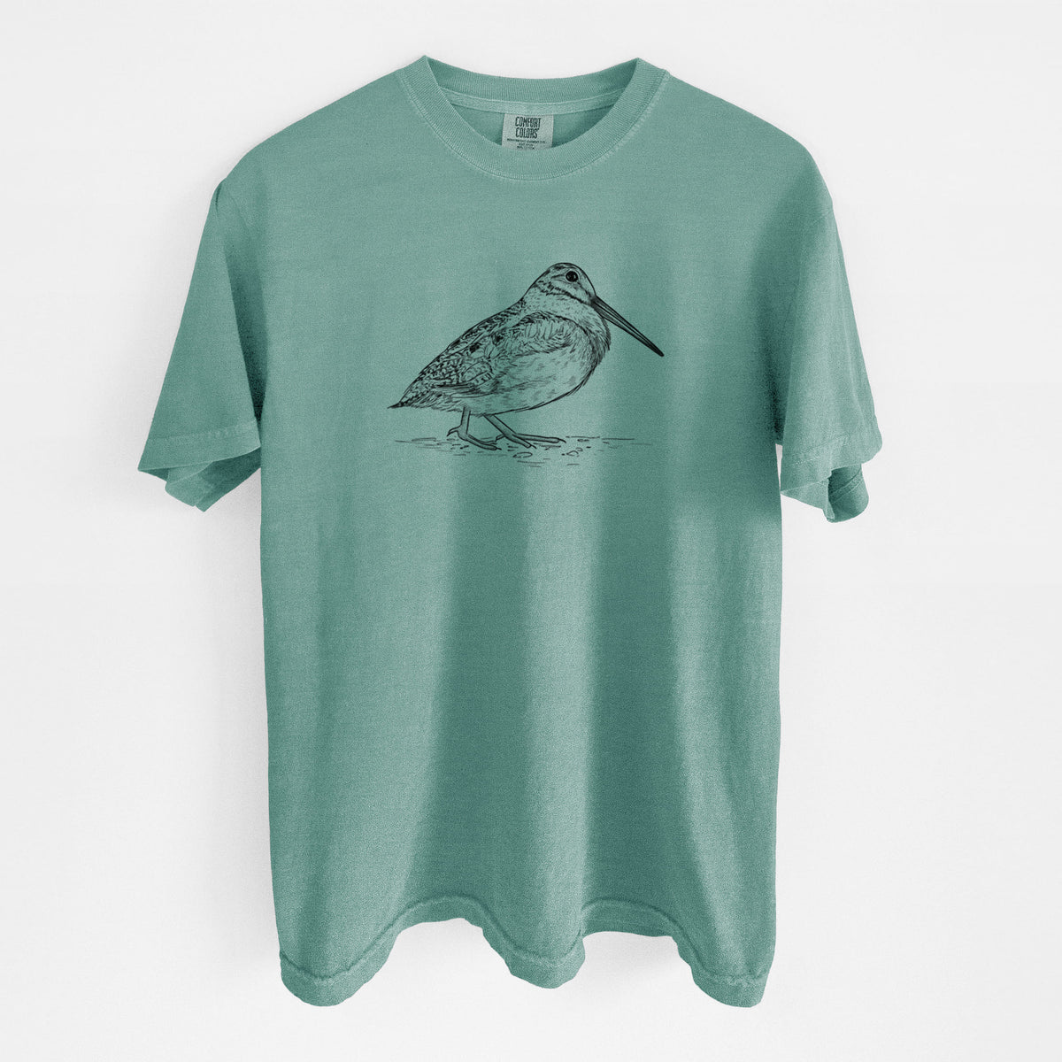 Reef green Comfort Colors t-shirt laid flat, printed with a detailed black ink sketch of an American woodcock standing on the ground.