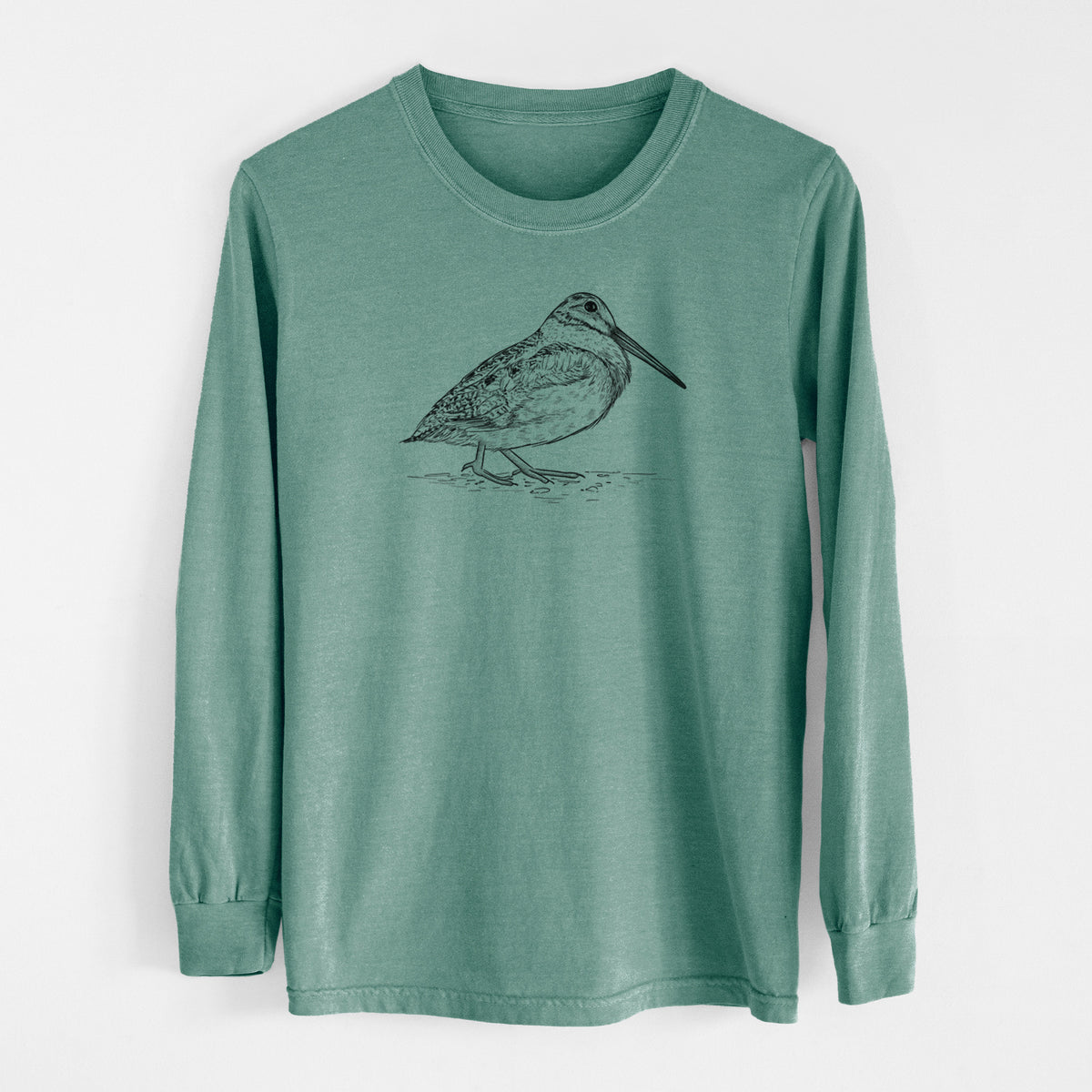 Pine green Comfort Colors long sleeve shirt laid flat, printed with a detailed black ink sketch of an American woodcock standing on the ground.
