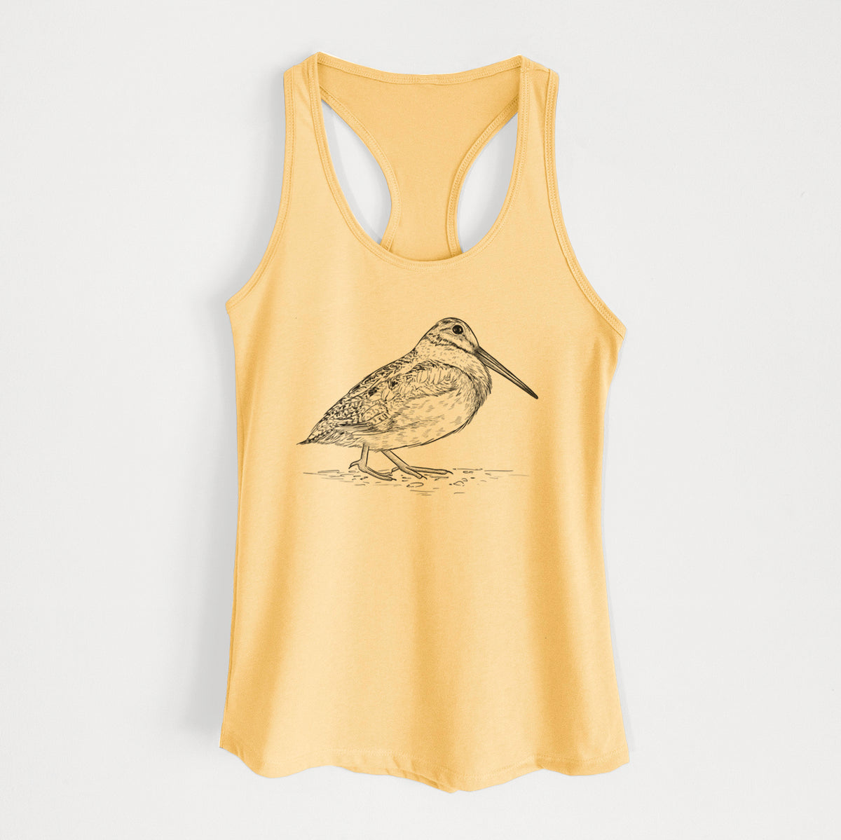 Banana cream women's racerback tank top laid flat, printed with a detailed black ink sketch of an American woodcock standing on the ground.