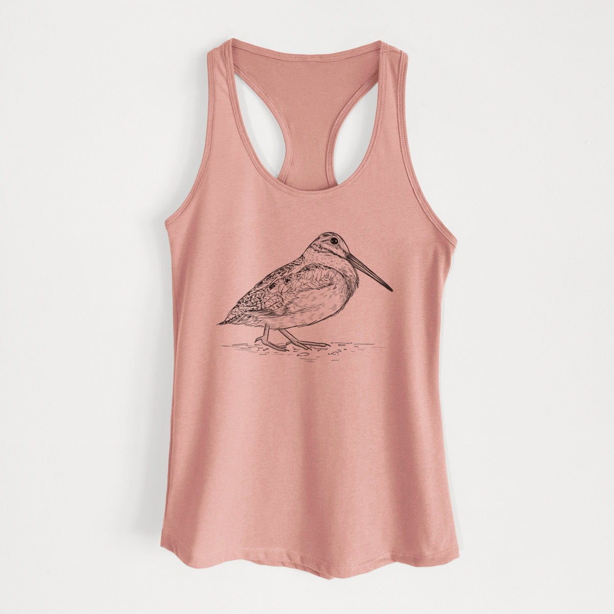 Desert pink women's racerback tank top laid flat, printed with a detailed black ink sketch of an American woodcock standing on the ground.