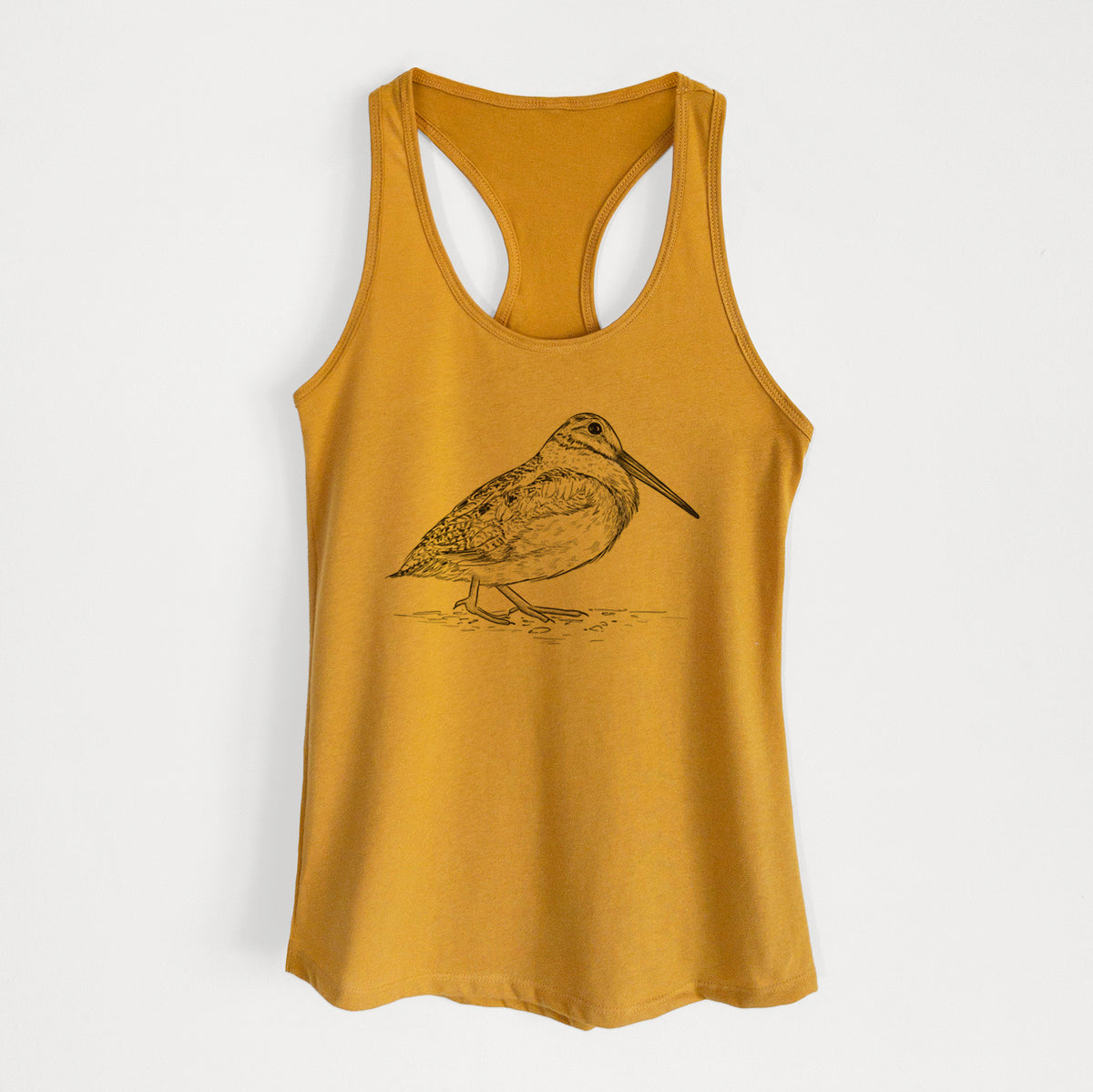 Gold women's racerback tank top laid flat, printed with a detailed black ink sketch of an American woodcock standing on the ground.