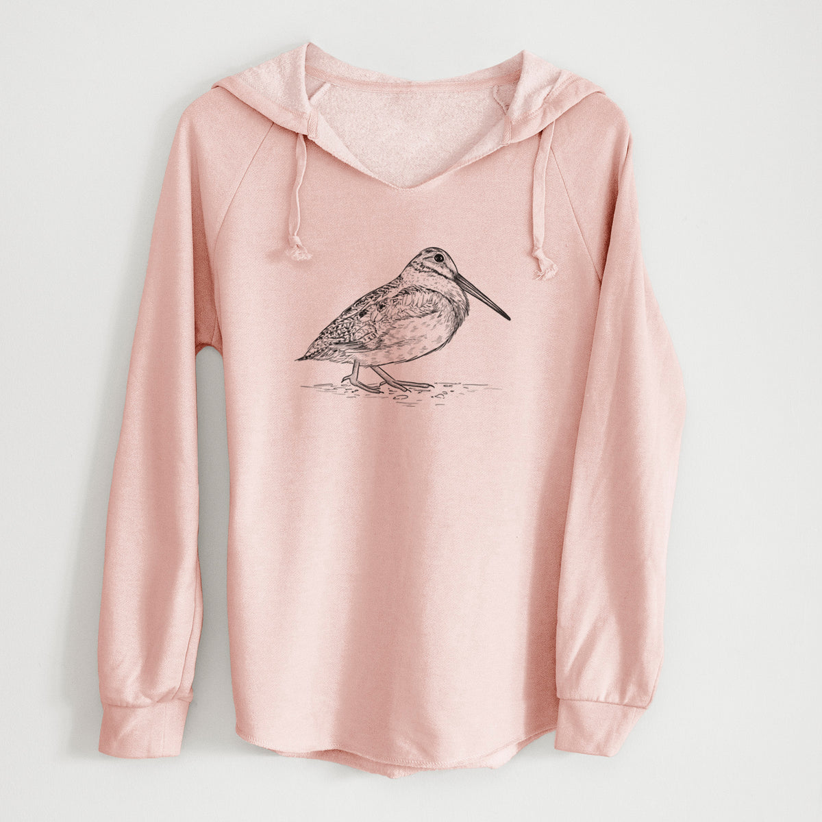 Blush pink women's Cali Wave hooded sweatshirt laid flat, printed with a detailed black ink sketch of an American woodcock standing on the ground.