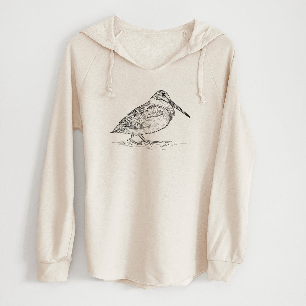 Bone cream women's Cali Wave hooded sweatshirt laid flat, printed with a detailed black ink sketch of an American woodcock standing on the ground.
