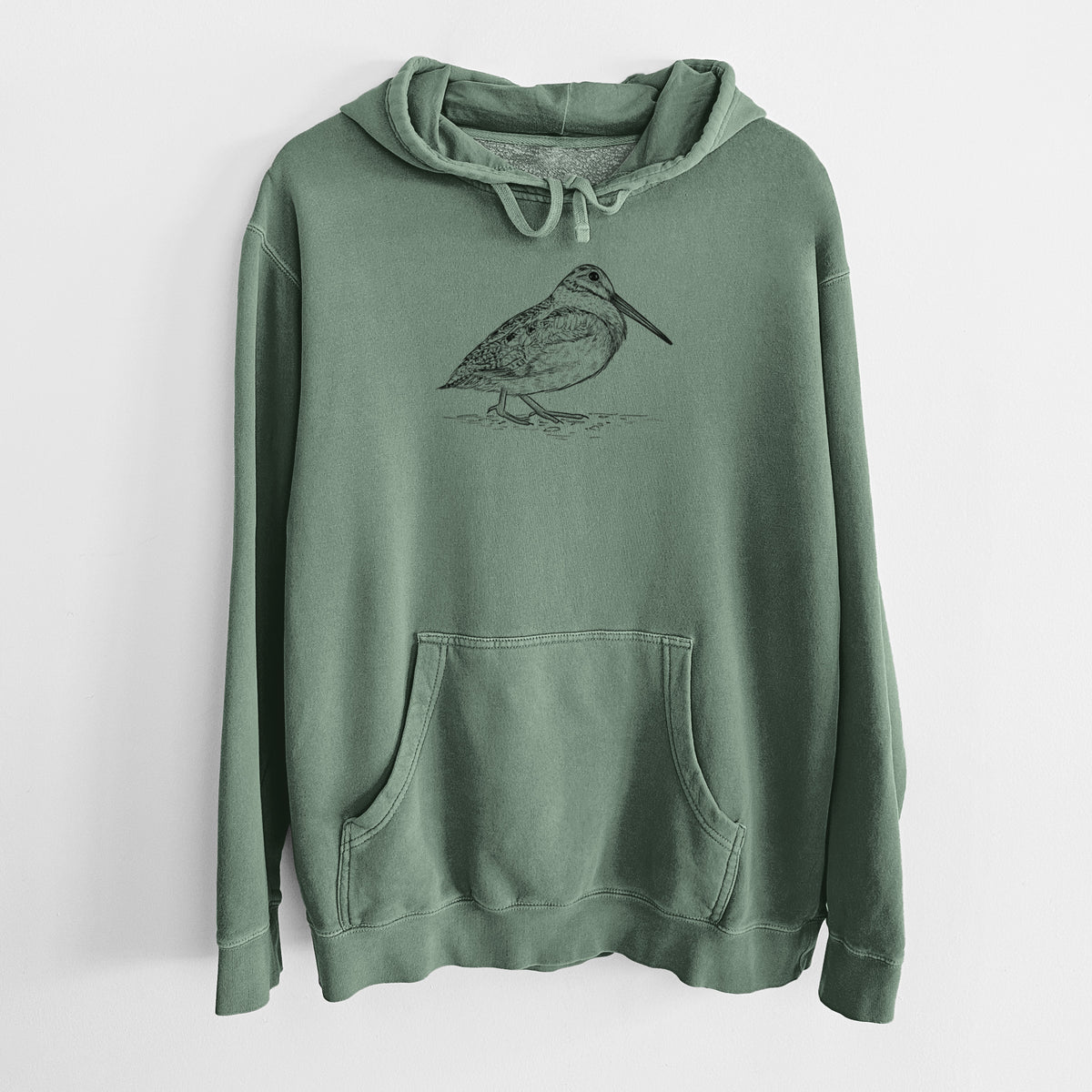 Alpine green pigment dyed hoodie laid flat, printed with a detailed black ink sketch of an American woodcock standing on the ground.