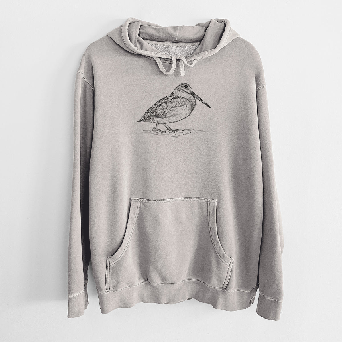 Cement grey pigment dyed hoodie laid flat, printed with a detailed black ink sketch of an American woodcock standing on the ground.