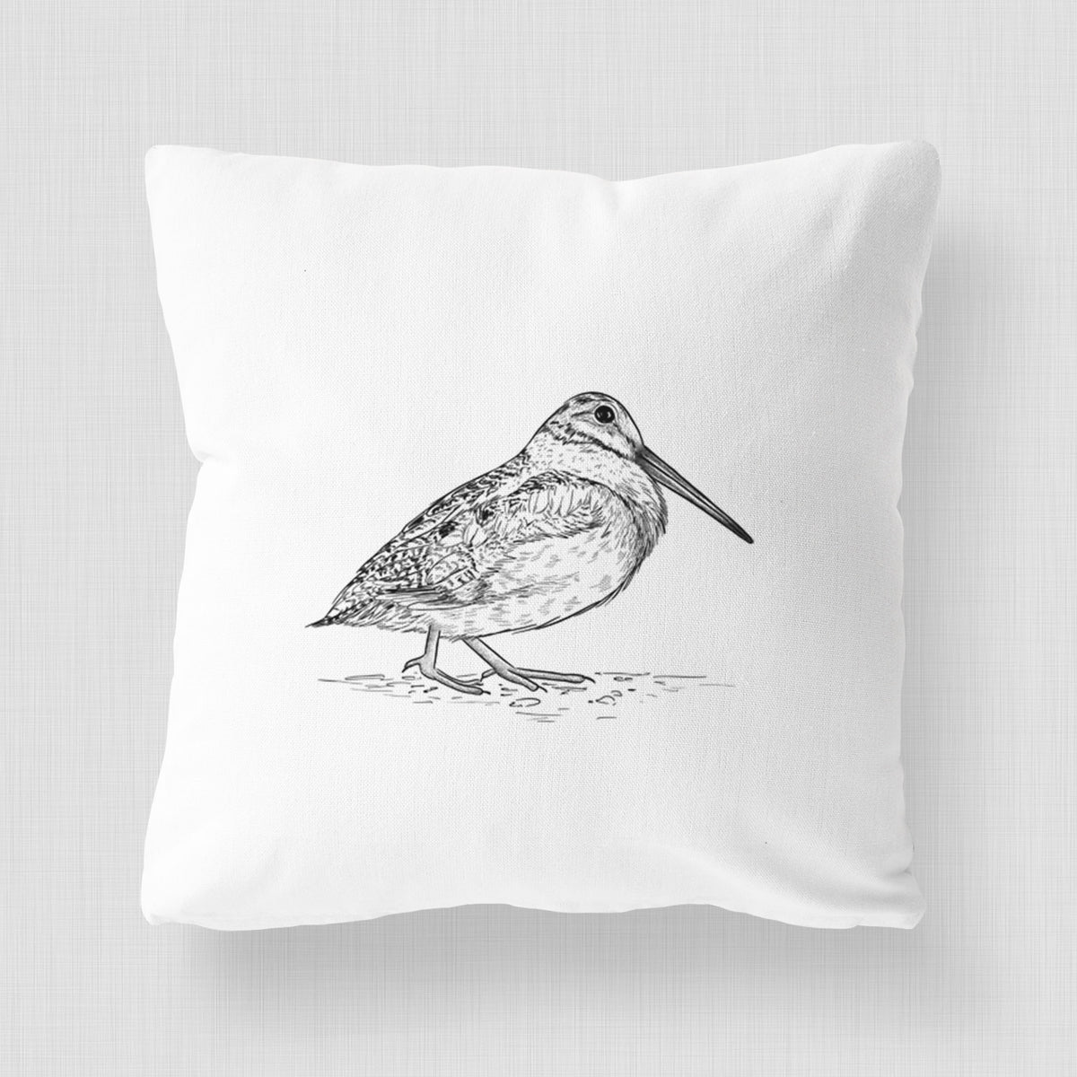 White pillow cover printed with a detailed black ink sketch of an American woodcock standing on the ground.