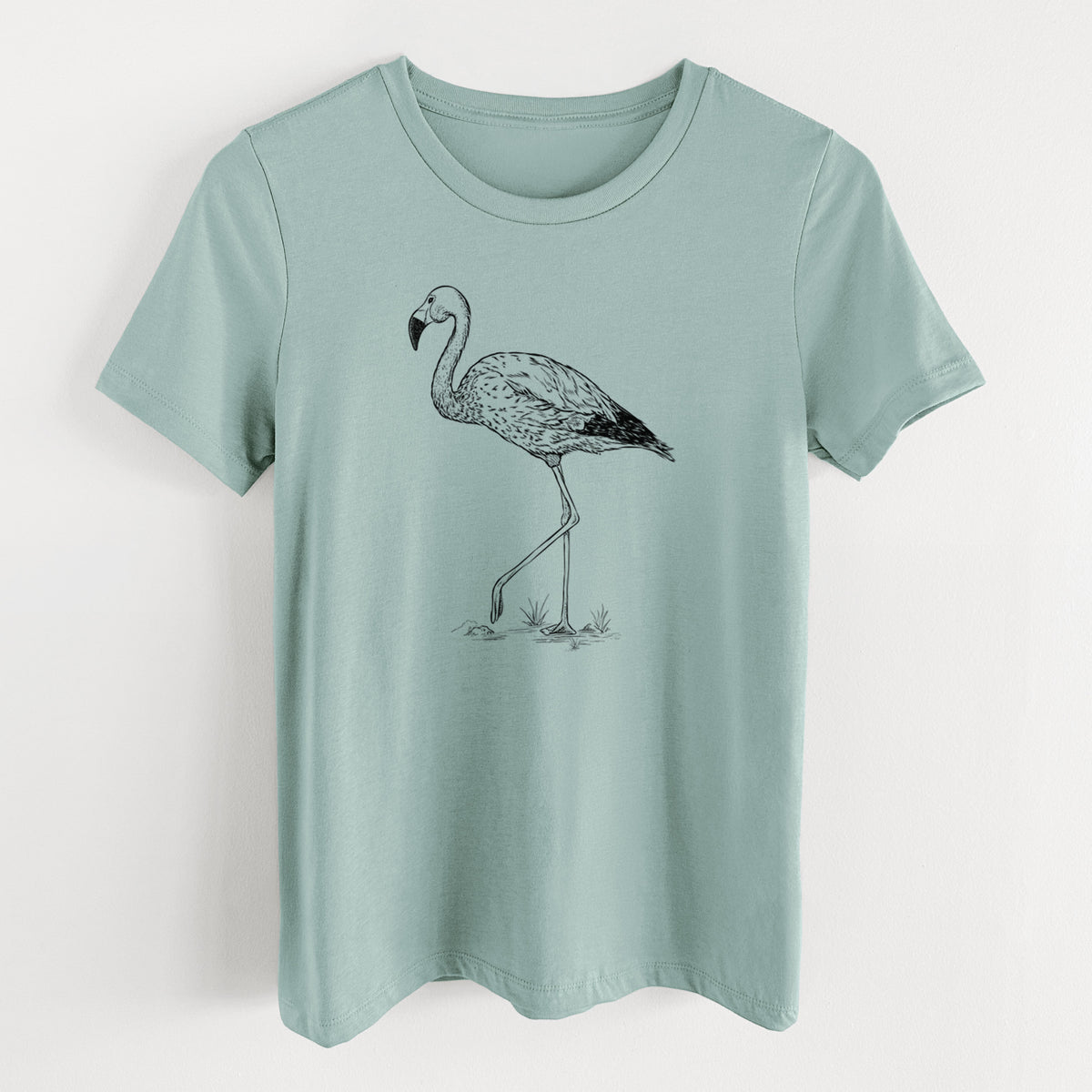 Dusty blue women's relaxed fit cotton t-shirt laid flat, printed with a black ink illustration of an Andean flamingo standing on one leg.