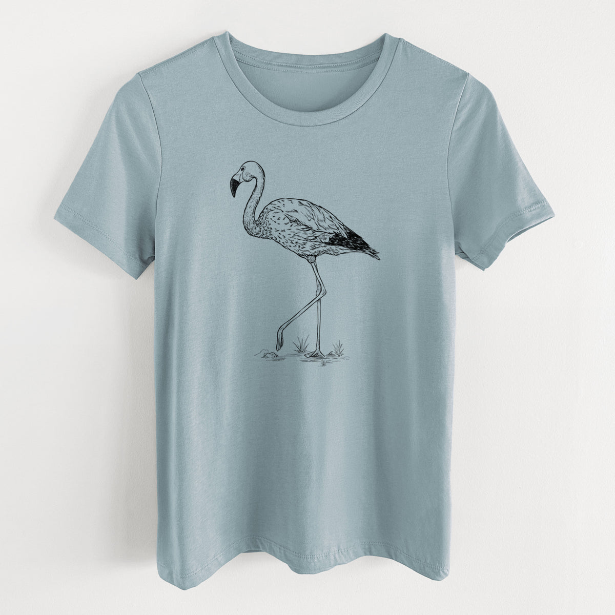 Vintage denim women's relaxed fit cotton t-shirt laid flat, printed with a black ink illustration of an Andean flamingo standing on one leg.
