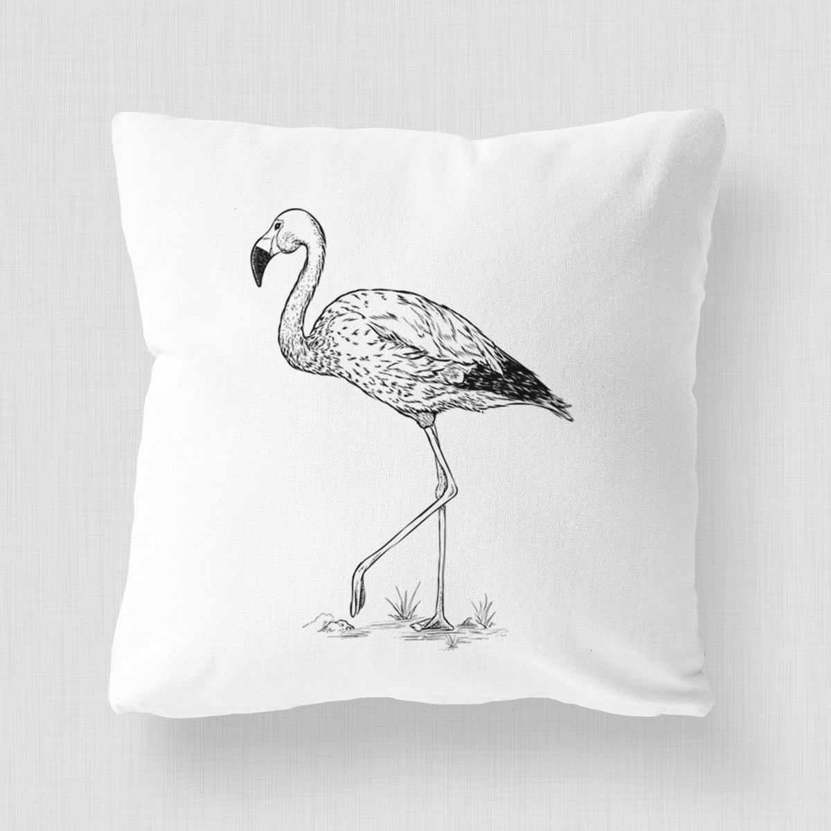 White pillow cover printed with a black ink illustration of an Andean flamingo standing on one leg.