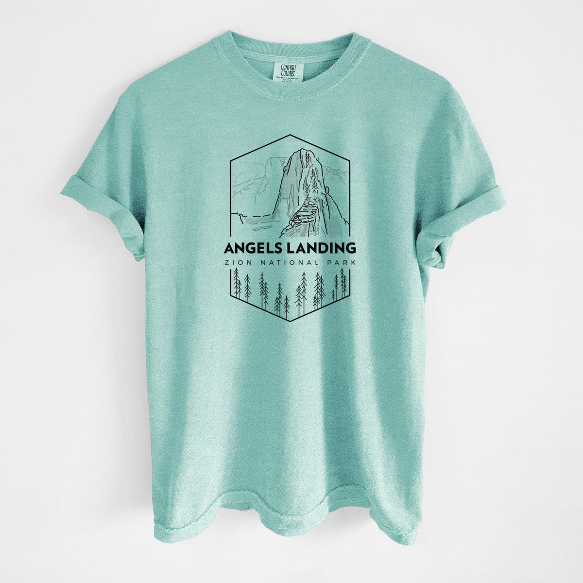 Chalky mint Comfort Colors t-shirt laid flat, printed with a black line art badge of Angels Landing above pine trees, with the words Angels Landing, Zion National Park.