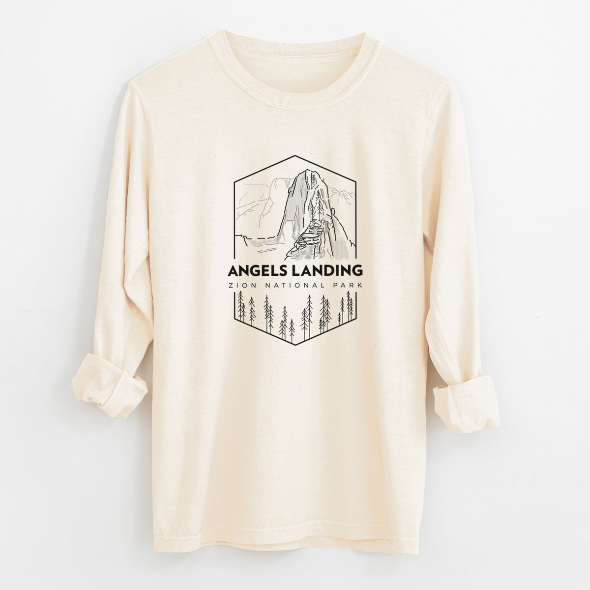Ivory Comfort Colors long sleeve shirt laid flat with the cuffs rolled, printed with a black line art badge of Angels Landing above pine trees, with the words Angels Landing, Zion National Park.