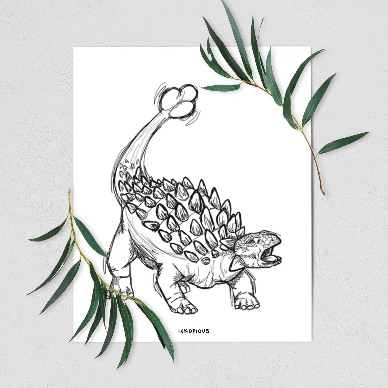 Art print of a black ink illustration of an Ankylosaurus with its club tail raised, shown with eucalyptus leaves.