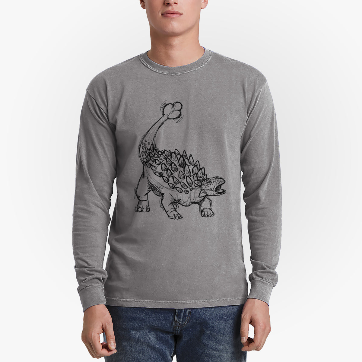 Man wearing a grey Comfort Colors long sleeve shirt printed with a black ink illustration of an Ankylosaurus with its club tail raised.