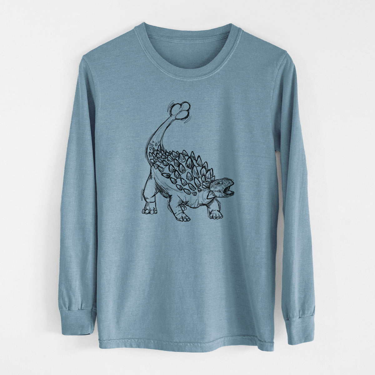 Steel blue Comfort Colors long sleeve shirt laid flat, printed with a black ink illustration of an Ankylosaurus with its club tail raised.