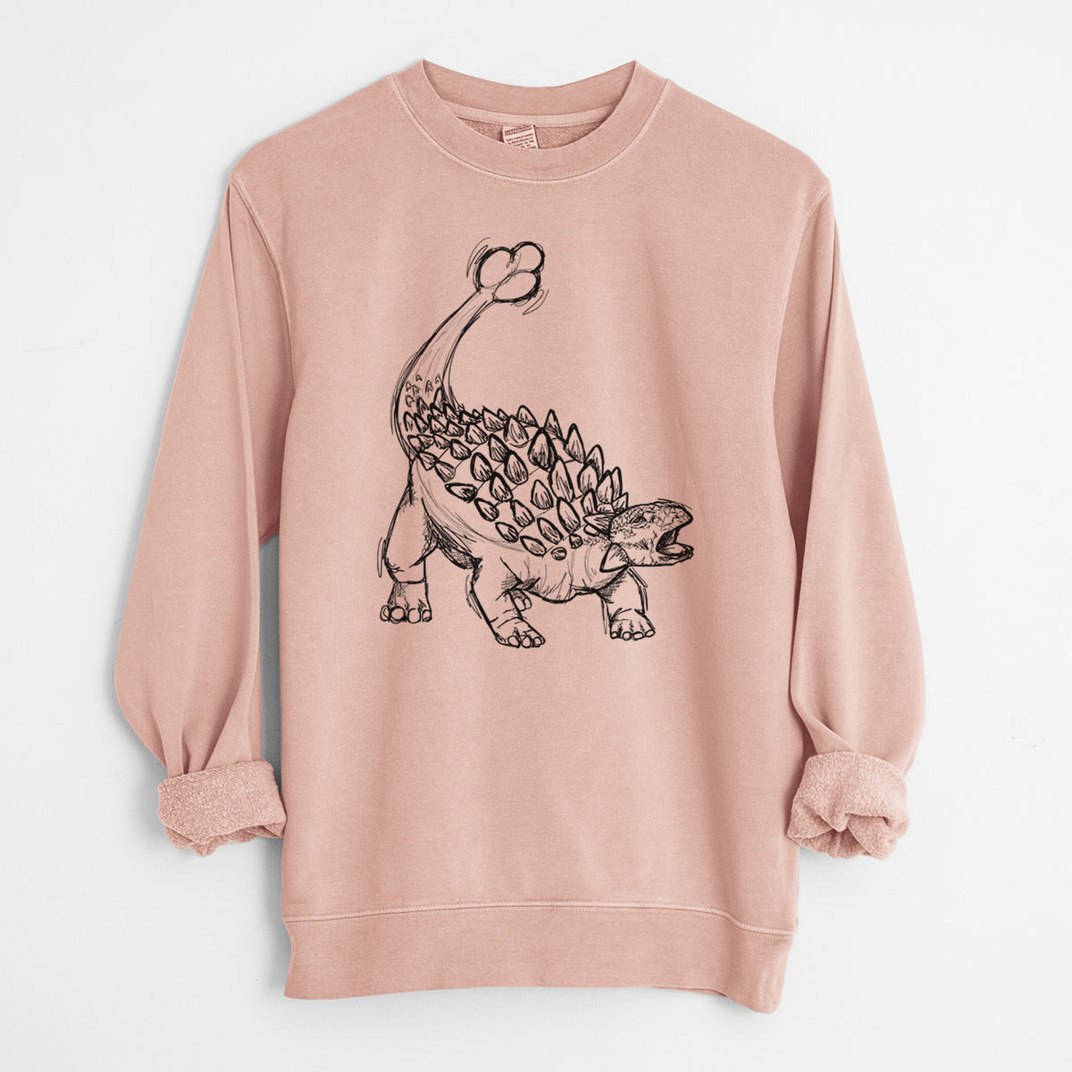 Dusty pink pigment dyed crewneck sweatshirt laid flat with the sleeves rolled, printed with a black ink illustration of an Ankylosaurus with its club tail raised.