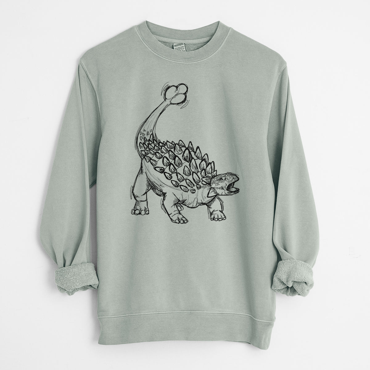 Sage green pigment dyed crewneck sweatshirt laid flat with the sleeves rolled, printed with a black ink illustration of an Ankylosaurus with its club tail raised.
