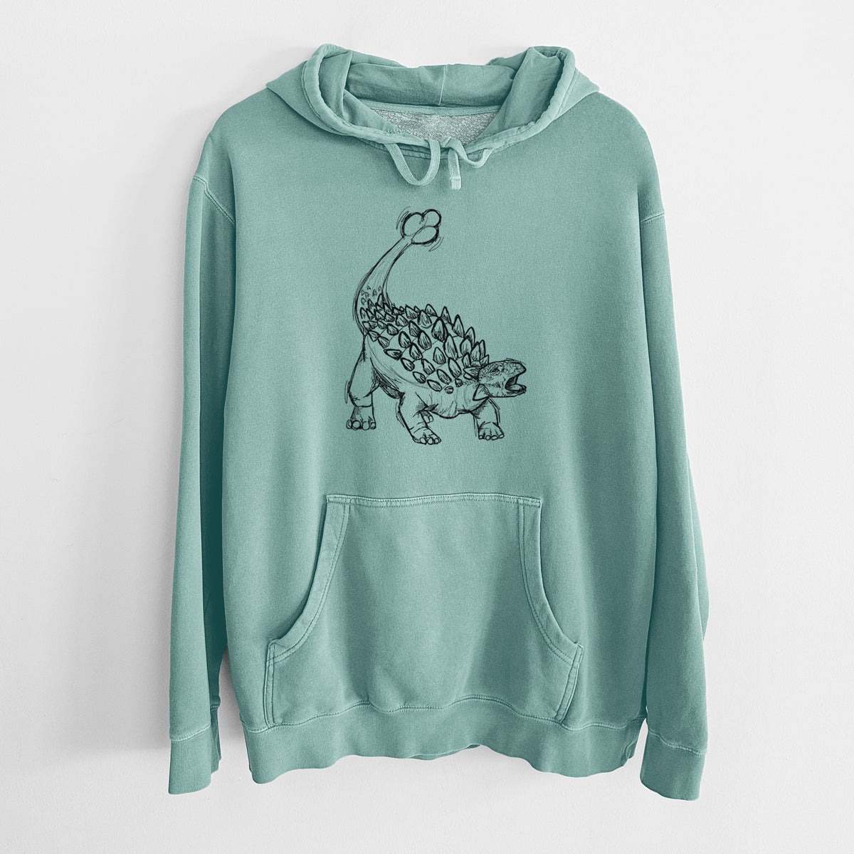 Mint green pigment dyed hoodie laid flat, printed with a black ink illustration of an Ankylosaurus with its club tail raised.