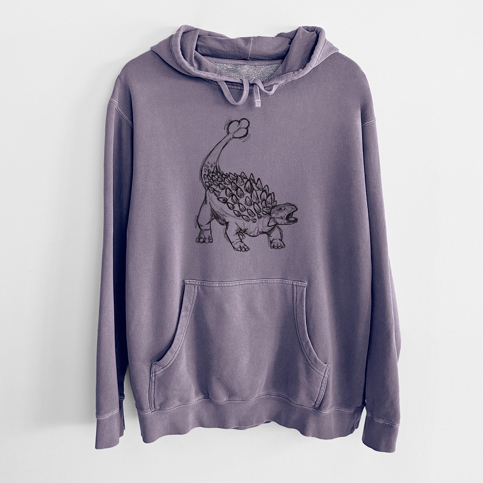 Plum purple pigment dyed hoodie laid flat, printed with a black ink illustration of an Ankylosaurus with its club tail raised.