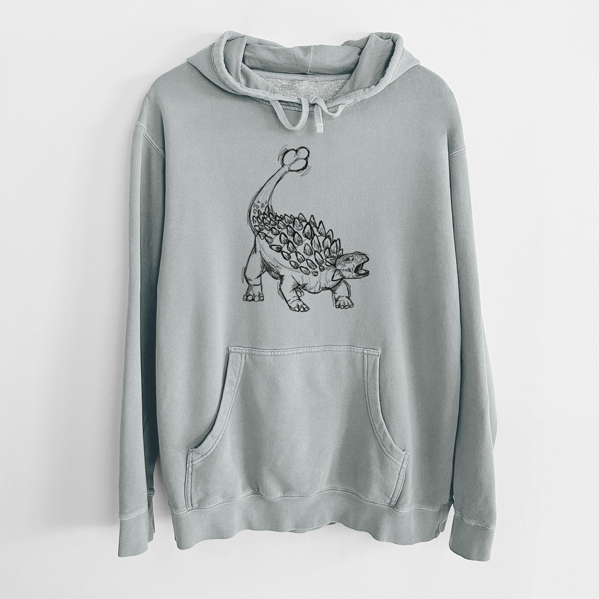 Sage green pigment dyed hoodie laid flat, printed with a black ink illustration of an Ankylosaurus with its club tail raised.