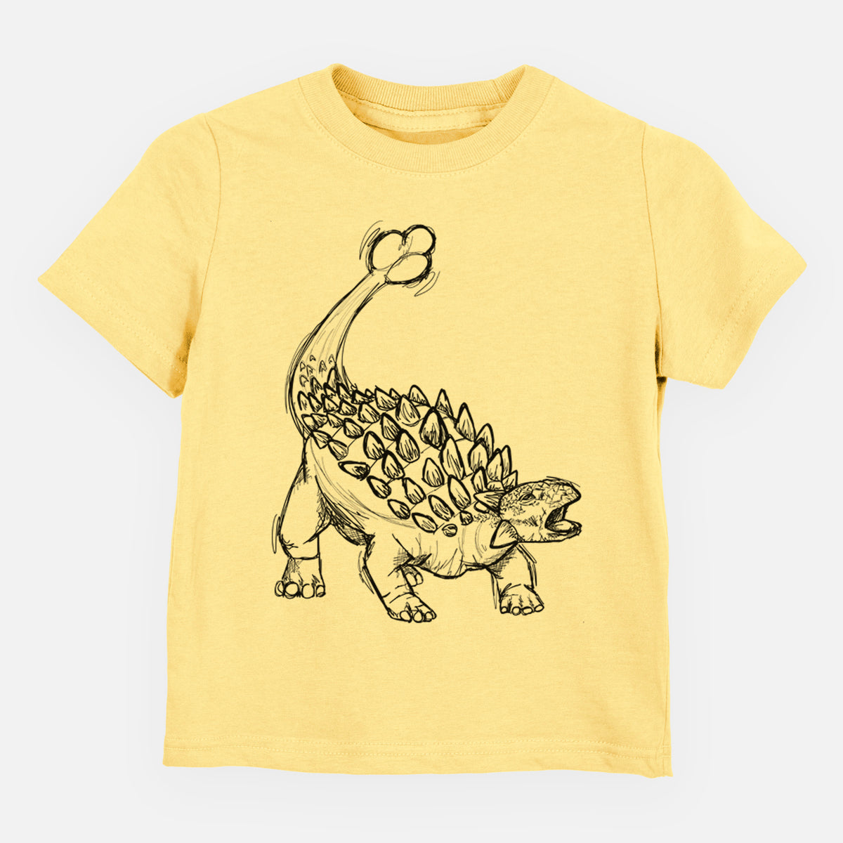 Butter yellow toddler t-shirt laid flat, printed with a black ink illustration of an Ankylosaurus with its club tail raised.
