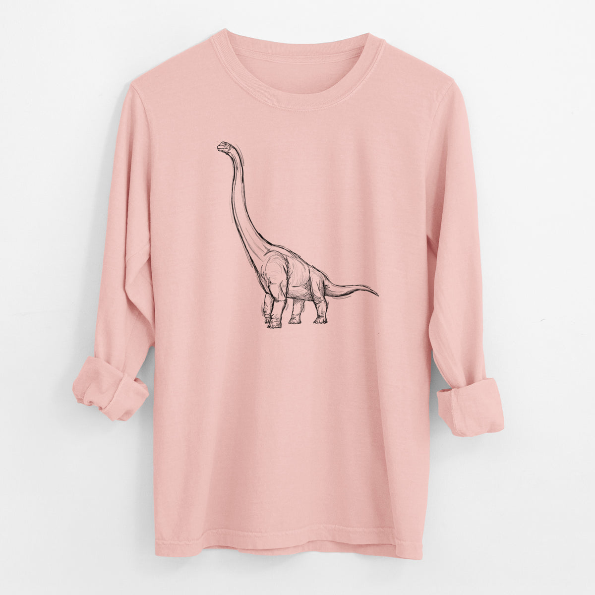 Peachy Comfort Colors long sleeve shirt laid flat with the cuffs rolled, printed with a black ink illustration of a long-necked Apatosaurus walking.