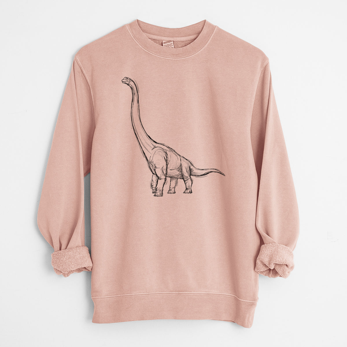 Dusty pink pigment dyed crewneck sweatshirt laid flat with the sleeves rolled, printed with a black ink illustration of a long-necked Apatosaurus walking.