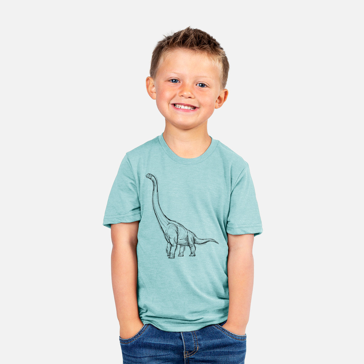 Smiling boy wearing a youth t-shirt printed with a black ink illustration of a long-necked Apatosaurus walking.