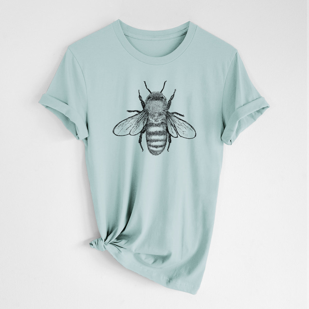 Dusty blue lightweight cotton t-shirt laid flat with the sleeves rolled, printed with a detailed black ink illustration of a honey bee with its wings spread, seen from above.