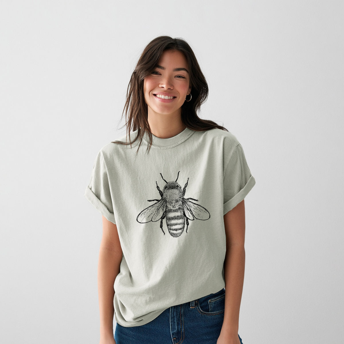 Female model organic cotton t-shirt printed with a detailed black ink illustration of a honey bee with its wings spread, seen from above.