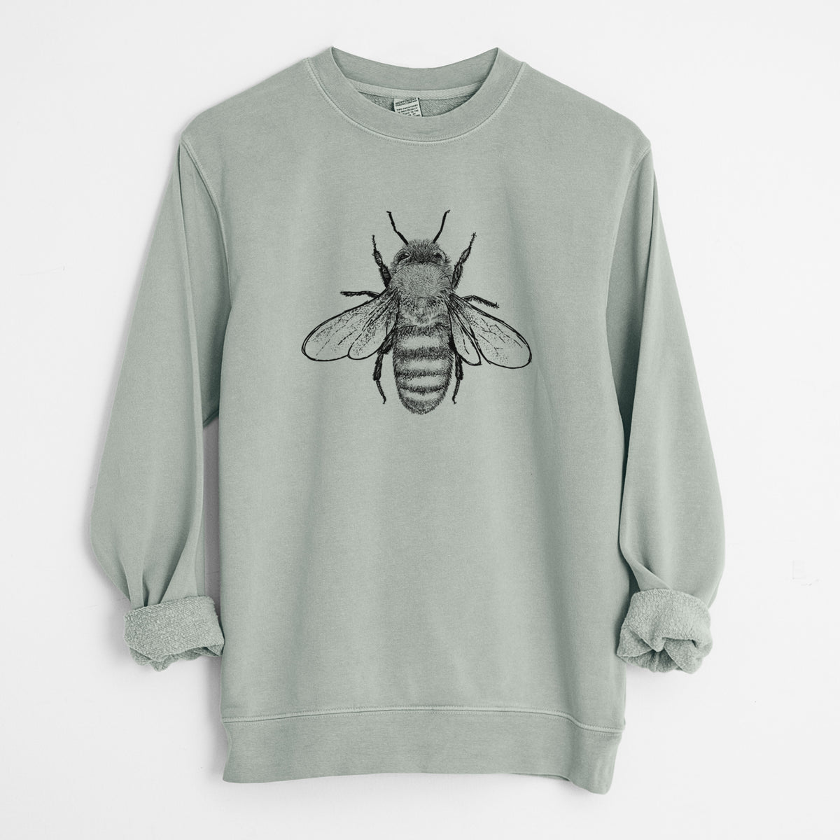 Sage green pigment dyed crewneck sweatshirt laid flat with the sleeves rolled, printed with a detailed black ink illustration of a honey bee with its wings spread, seen from above.