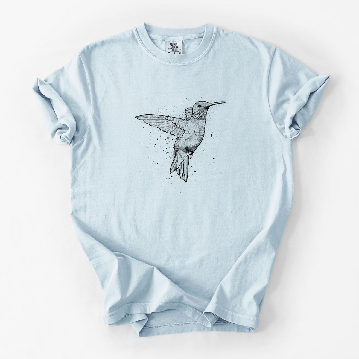 Chambray blue Comfort Colors t-shirt laid flat, printed with a black ink sketch of a ruby-throated hummingbird hovering with its wings raised.