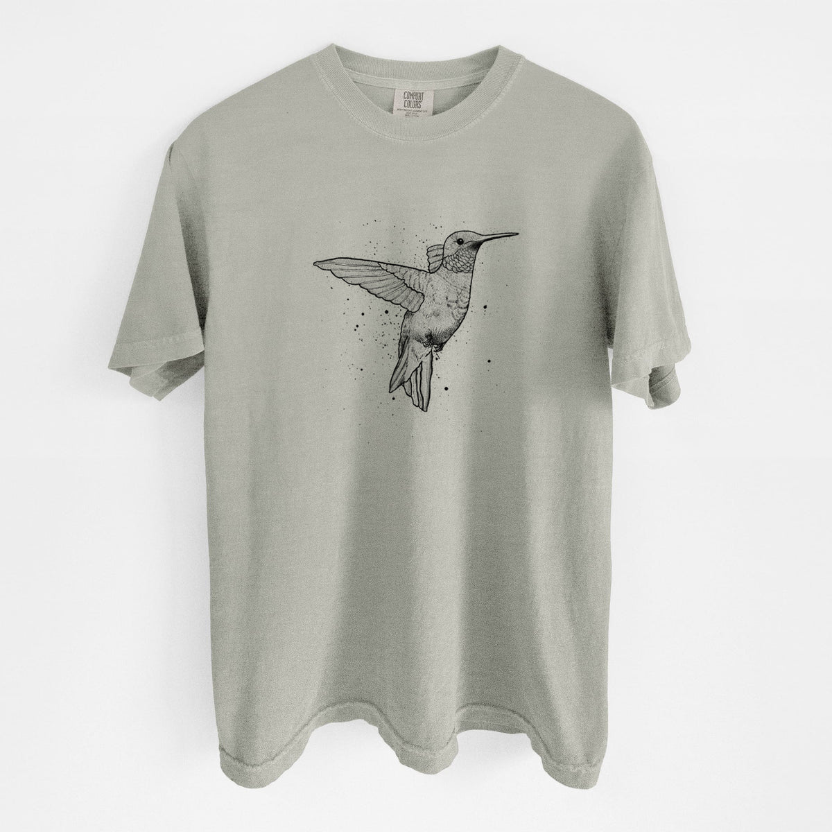 Sandstone beige Comfort Colors t-shirt laid flat, printed with a black ink sketch of a ruby-throated hummingbird hovering with its wings raised.