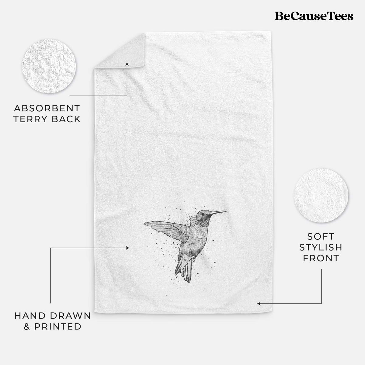 White hand towel printed with a black ink sketch of a ruby-throated hummingbird hovering with its wings raised.
