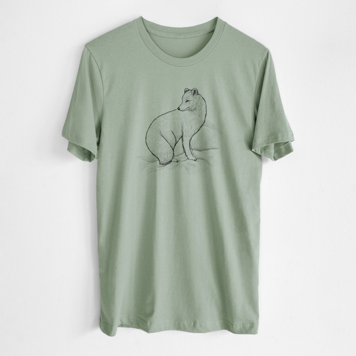 Sage green lightweight cotton t-shirt laid flat, printed with a black ink illustration of an arctic fox sitting in the snow.