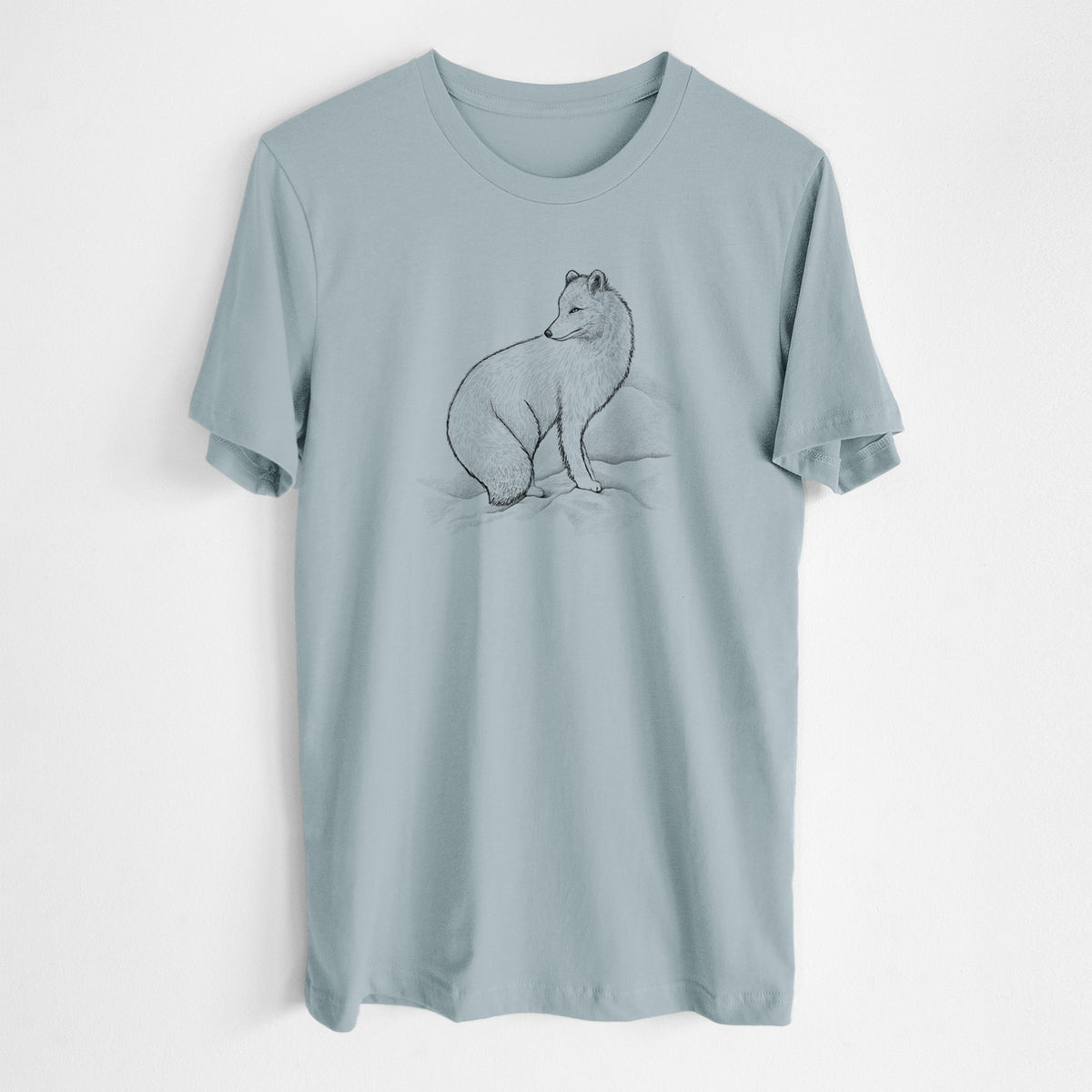 Vintage denim lightweight cotton t-shirt laid flat, printed with a black ink illustration of an arctic fox sitting in the snow.